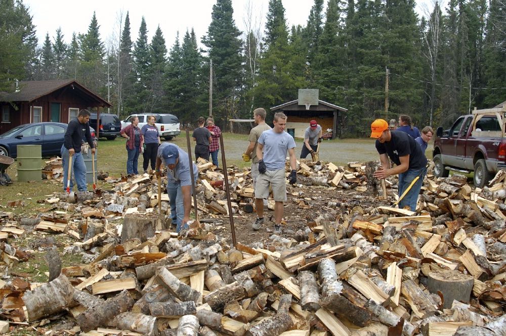 several people chopping wood