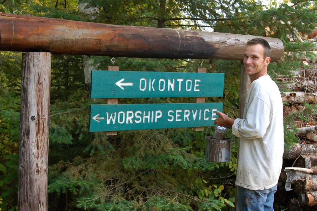 man staining camp signpost