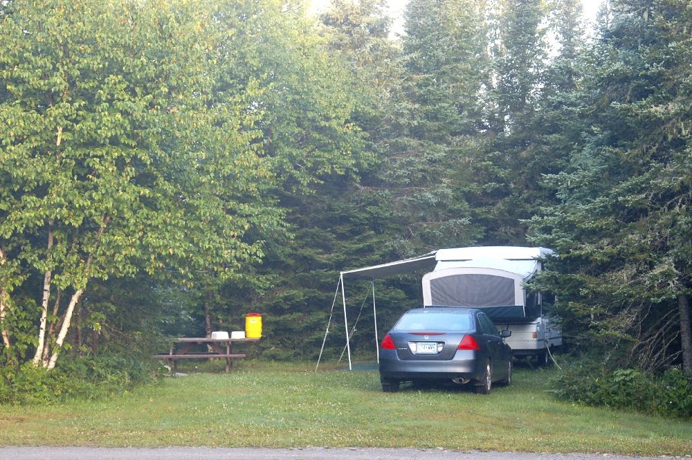 campsite with a car and camper