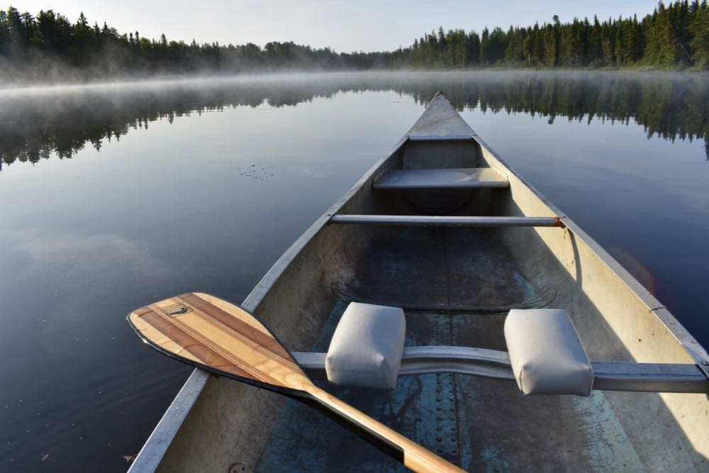 canoe and paddle on a calm lake