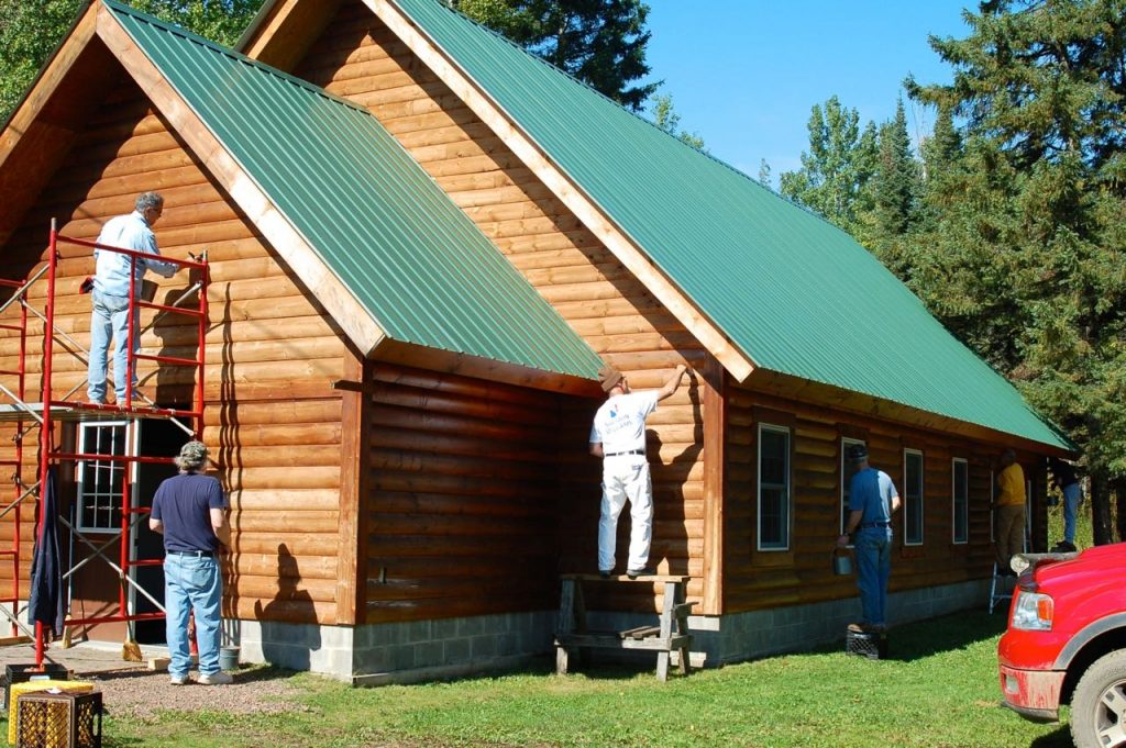 a few men staining Okontoe's Chapel