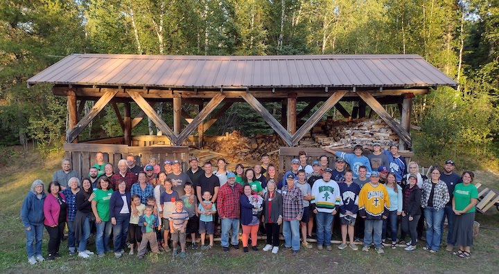 Family photo of the Barr family in front of the wood shed