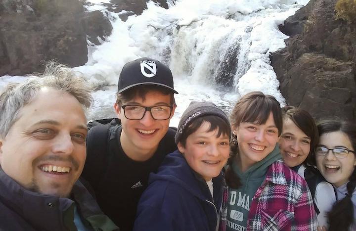 The Selin family in front of a frozen waterfall