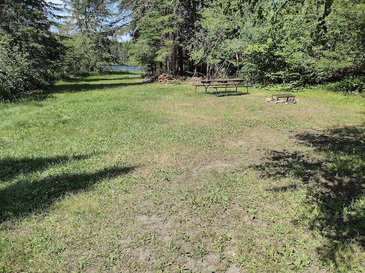 Campsite site with its large tent area, firepit and picnic table
