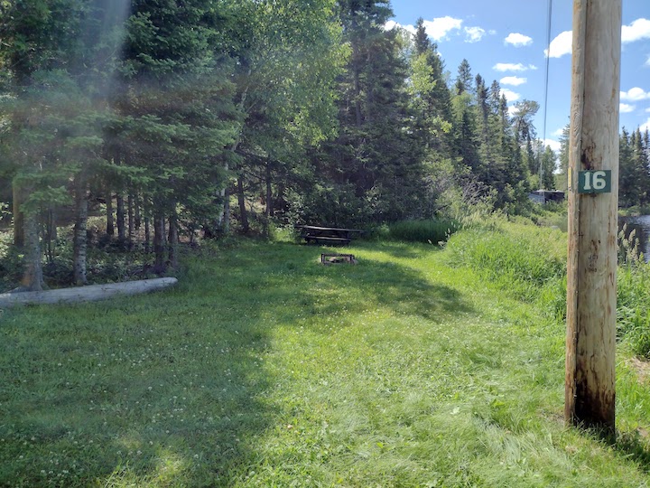 Campsite 16 with grassy area, firepit and picnic table