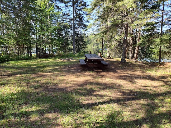 Campsite 4 with tent or small RV area, picnic table