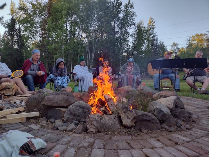 people gathered around a large campfire