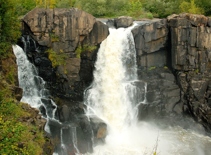 big waterfalls crash down basalt cliffs