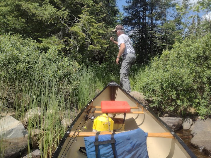 man getting ready to portage a canoe and gear