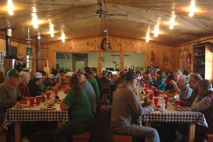 many people eating at long tables inside Okontoe's Dining Hall