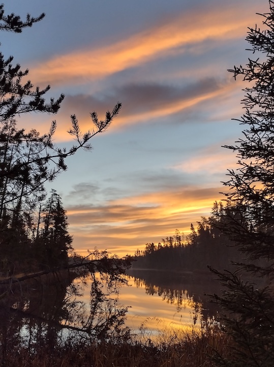 Orange clouds at dawn over Quiver Lake at Okontoe