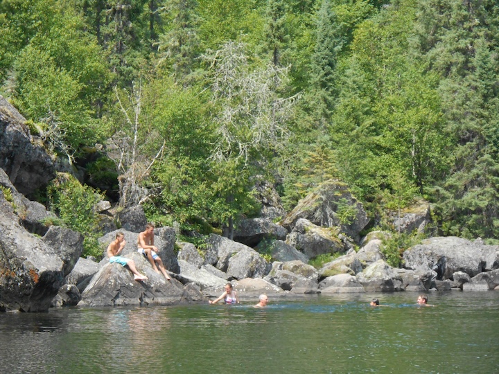 several people swim in a Boundary Waters lake