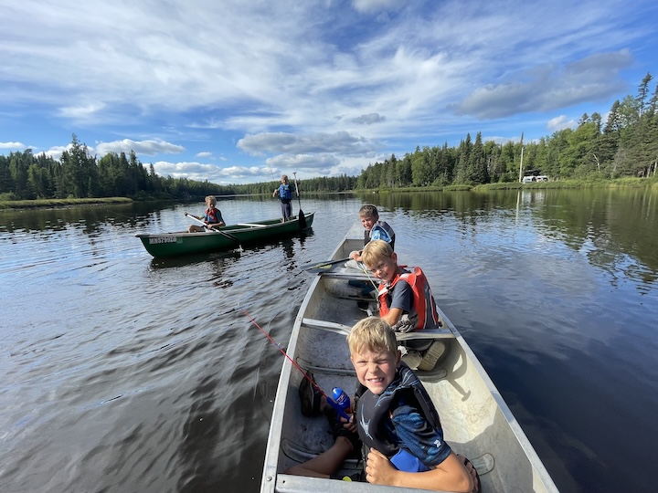 two canoes with five young boys between them fishing on Bow Lake at Okontoe