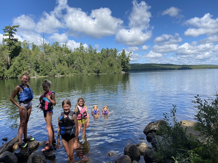 several young girls swim in Rose Lake in the Boundary Waters