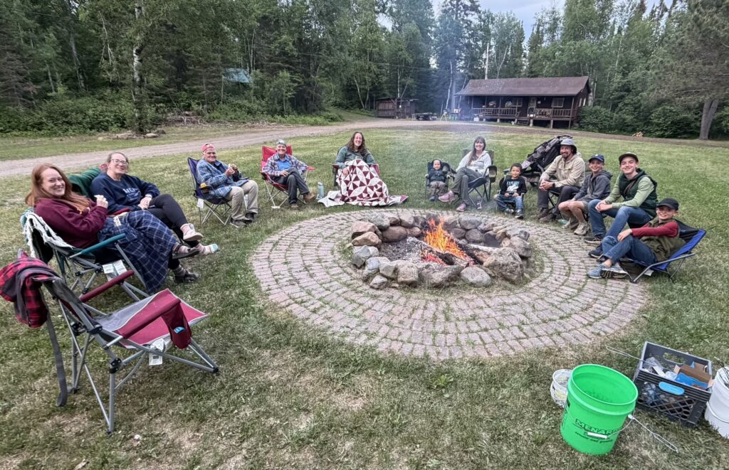 people sitting around Okontoe's community campfire